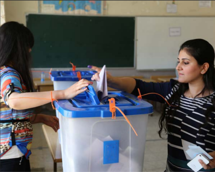 IRBIL, IRAQ - APRIL 30: An Iraqi woman casts her ballot in the Iraqi parliamentary elections at a polling station on April 30, 2014 in Irbil, Iraq.