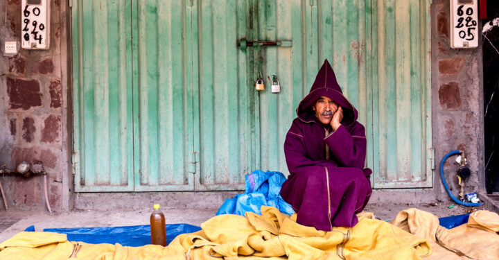 An Amazigh man sells men's jalabiyas in the village of Imlil, Atlas Mountains, Morocco, November 2016.